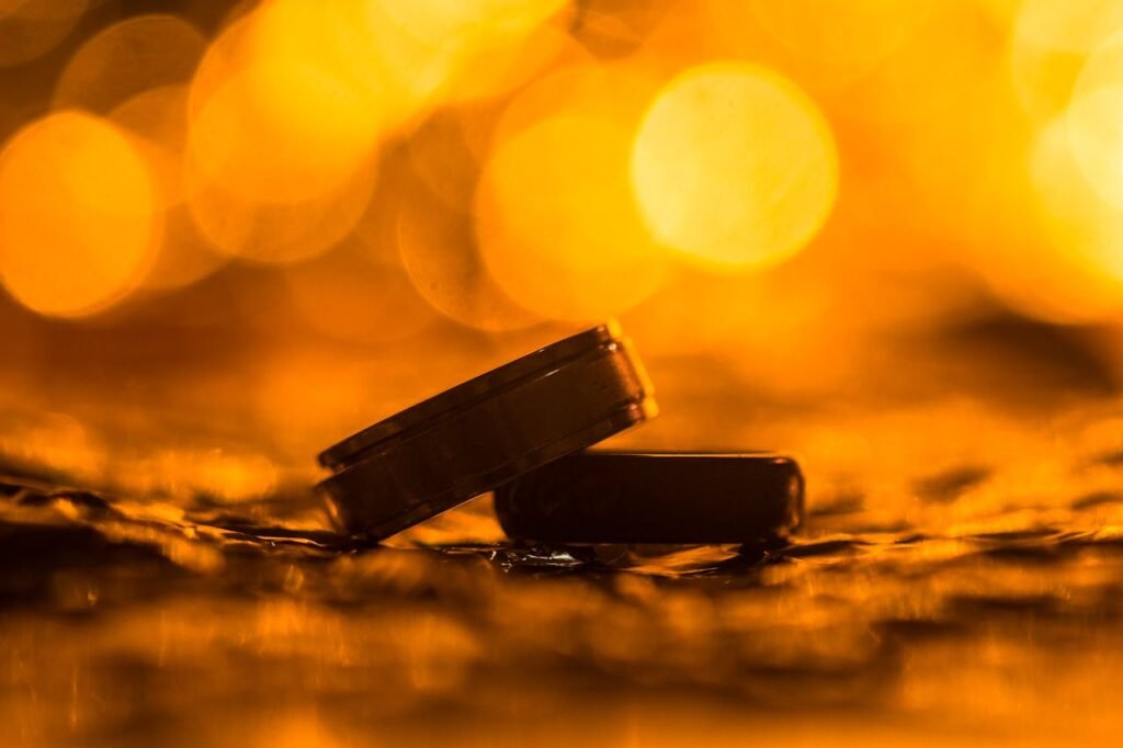 Close-up of golden wedding rings with a warm bokeh background, symbolizing love and unity.